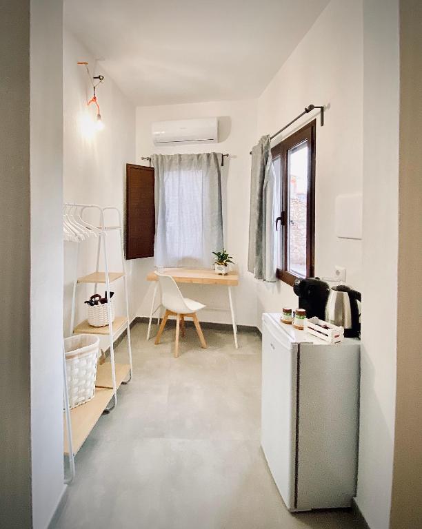 a small room with a table and a refrigerator at bedandclimbing in Baunei