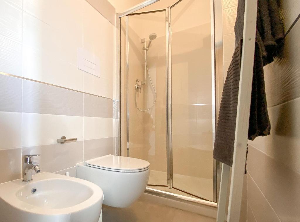 a bathroom with a shower and a toilet and a sink at bedandclimbing in Baunei
