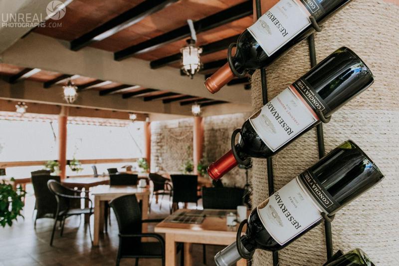 - un bouquet de bouteilles de vin accrochées au mur dans un restaurant dans l'établissement Hotel boutique Teocalli, à Tepoztlán
