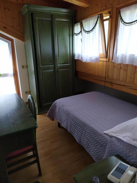 Posteľ alebo postele v izbe v ubytovaní Albergo Ristorante Cacciatori