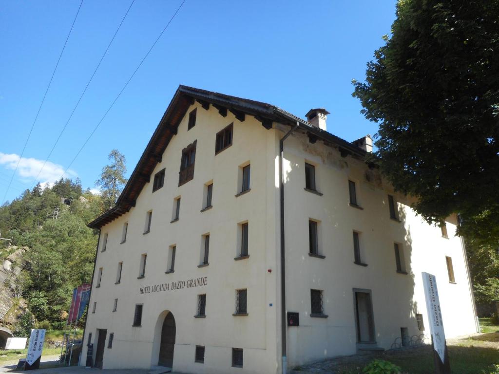 a large white building with a roof at Dazio Grande B&B in Rodi