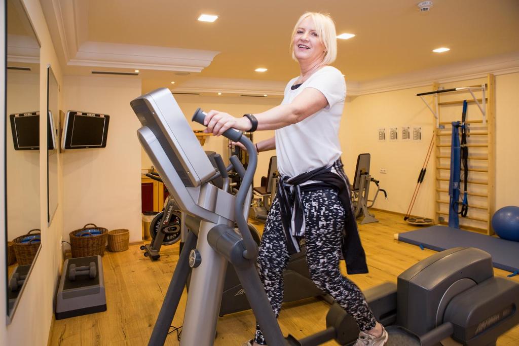 a woman on a treadmill in a gym at Hotel Zum Schwarzen Bären in Emmersdorf an der Donau
