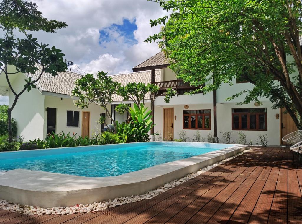 a swimming pool in front of a house at Hotel AONO in Chiang Mai