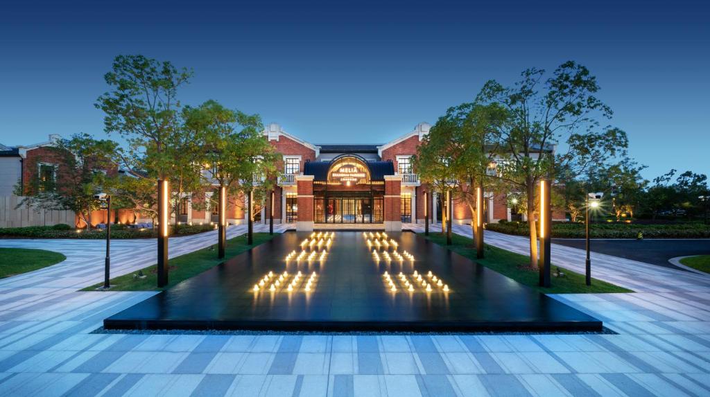 an exterior view of a building with a fountain at Melia Shanghai Parkside in Shanghai