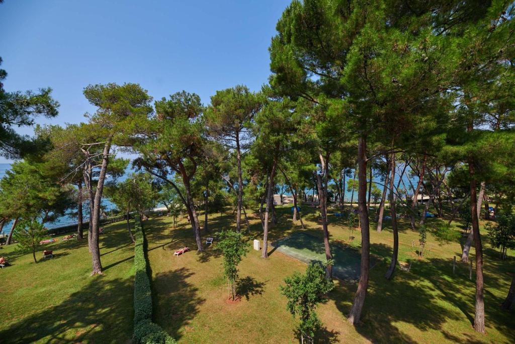 an aerial view of a park with trees at Hotel Parentium Plava Laguna in Poreč