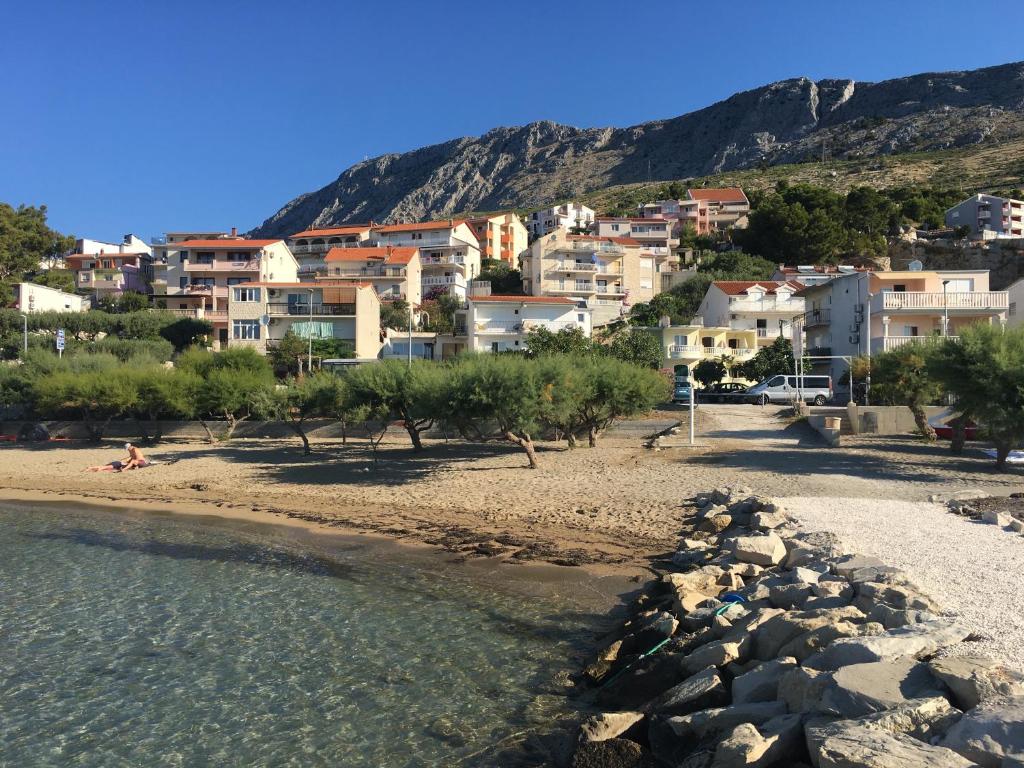 a view of a beach with houses on a hill at Apartment Duce in Omiš