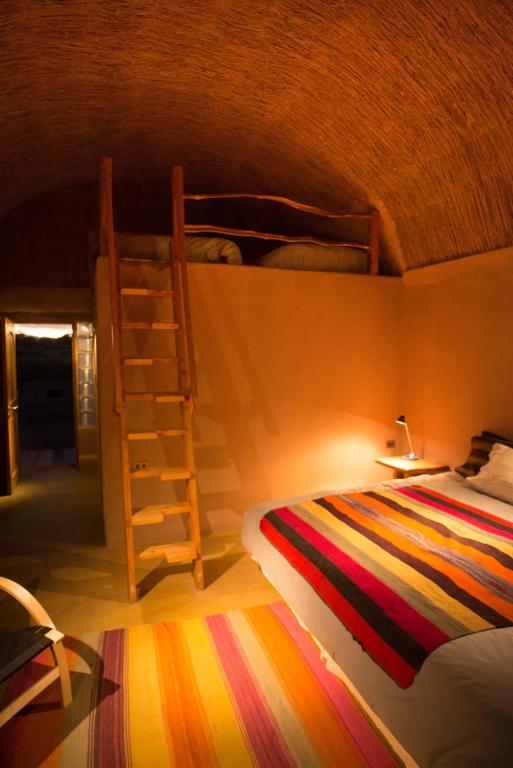 Postel nebo postele na pokoji v ubytování Planeta Atacama Lodge