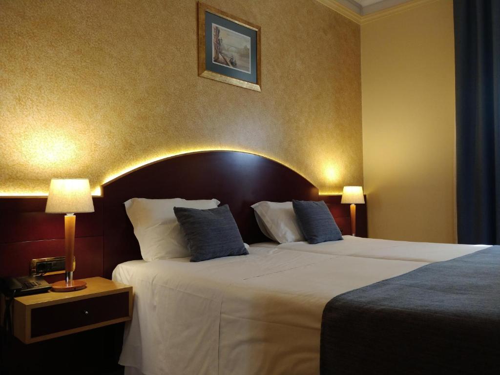 Cama ou camas em um quarto em Hotel Internacional Porto