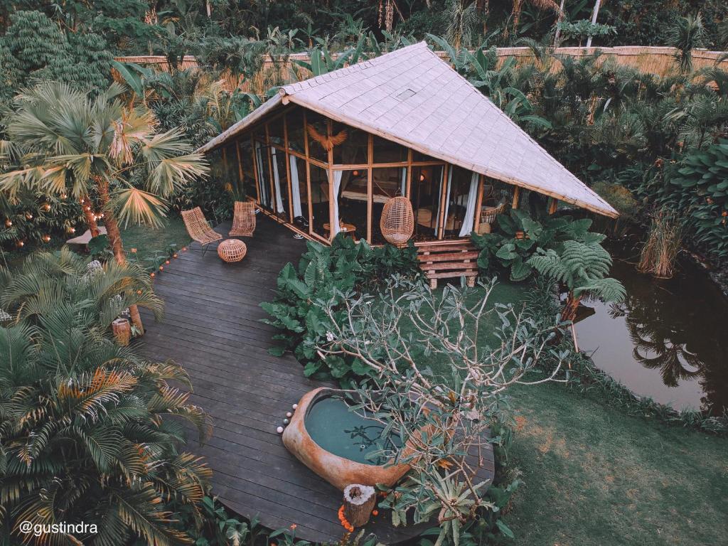 a wooden deck with a house in a garden at Hideout Falcon in Selat