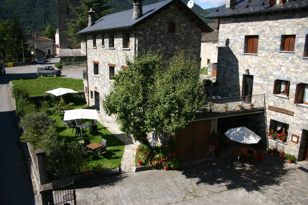 an overhead view of a building with a table and umbrella at Casa Gallán in Sarvisé