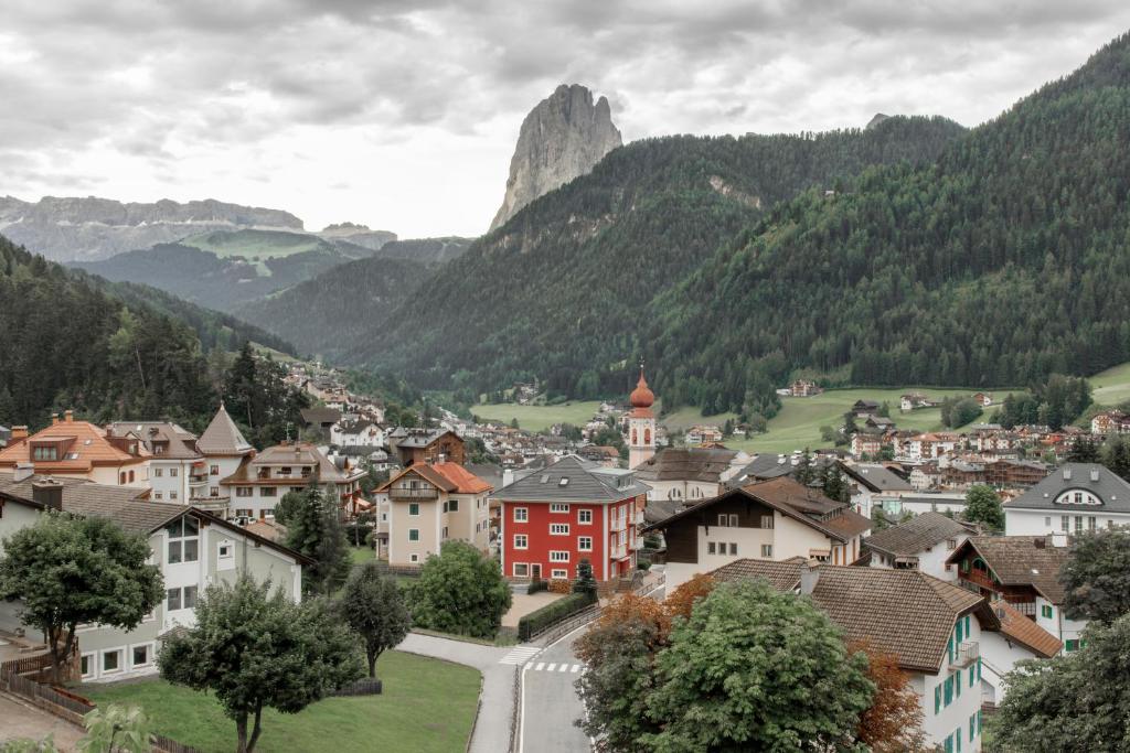 a town in a valley with a mountain in the background at Casa al Sole in Ortisei