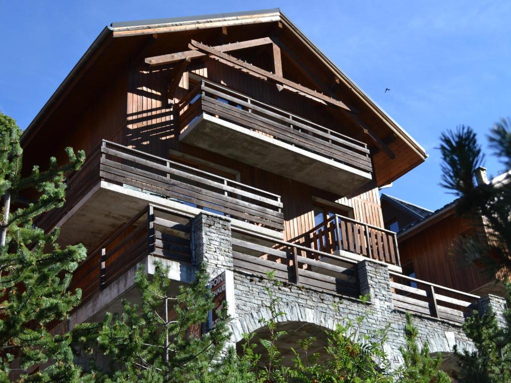 a building with wooden balconies on the side of it at VAUJANYLOCATIONS - Chalet De Marie in Vaujany