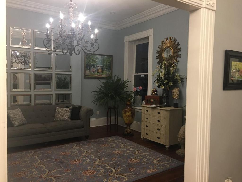 
a living room filled with furniture and flowers at WG Creole House 1850 in New Orleans
