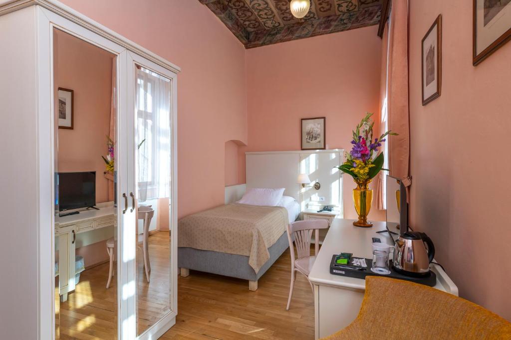 Postel nebo postele na pokoji v ubytování Hotel Cerny Slon