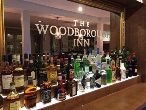 a display of bottles of alcohol on a counter in a store at The Woodborough Inn in Winscombe