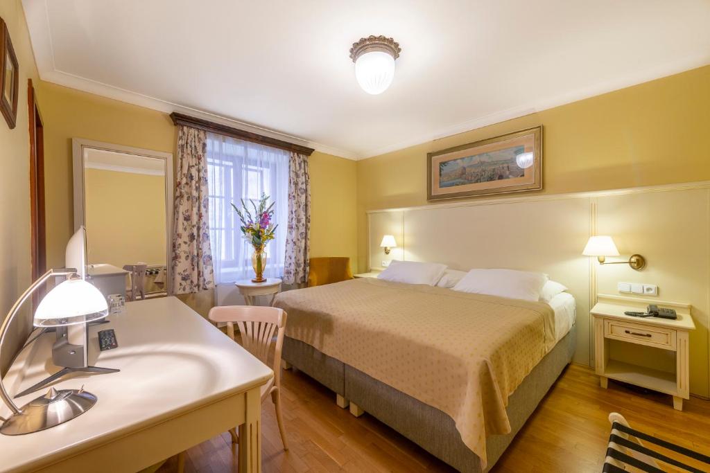 Postel nebo postele na pokoji v ubytování Hotel Cerny Slon