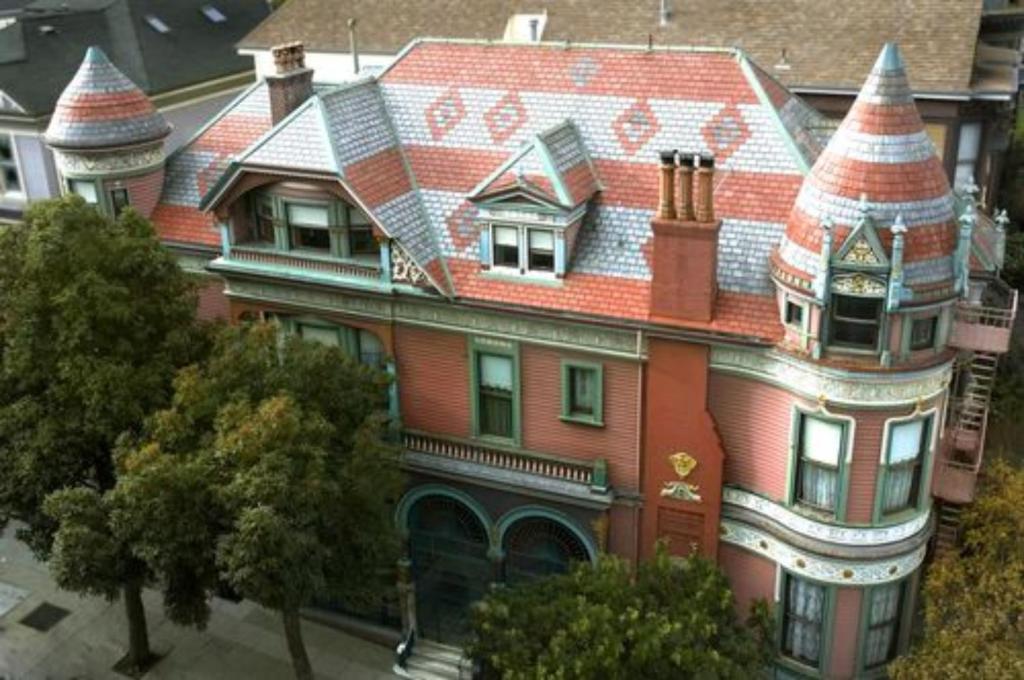 a large house with a clock tower on top of it at Chateau Tivoli Bed and Breakfast in San Francisco