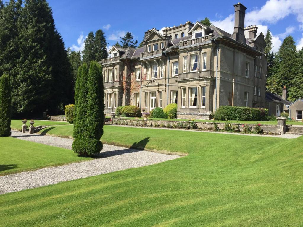 a large house with a lawn in front of it at Clonalis House - Guesthouse in Castlerea