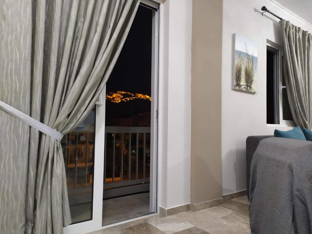 a room with a window with a view of the city at Nafplio City Apartments in Nafplio