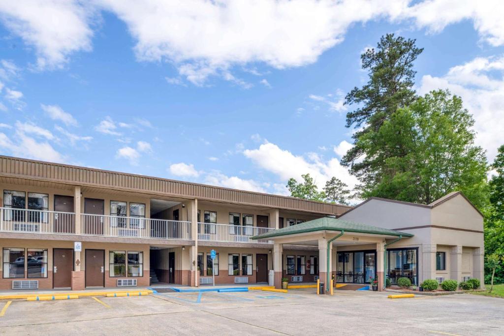 an exterior view of a building with a parking lot at Super 8 by Wyndham Gadsden AL in Gadsden