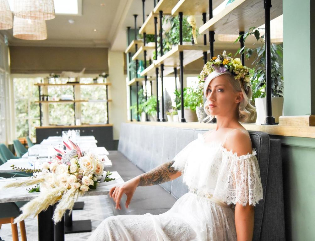 a bride in a wedding dress sitting at a table at The Marine in Whitstable