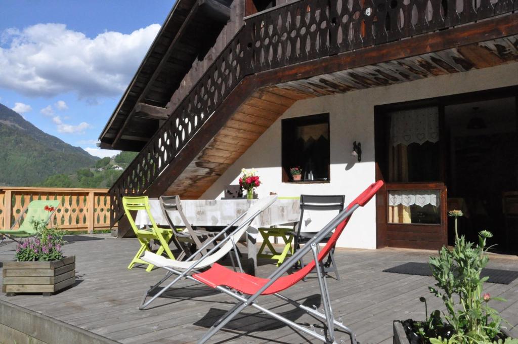 a patio with chairs and a table on a deck at La Grange Aux Loups in Queige