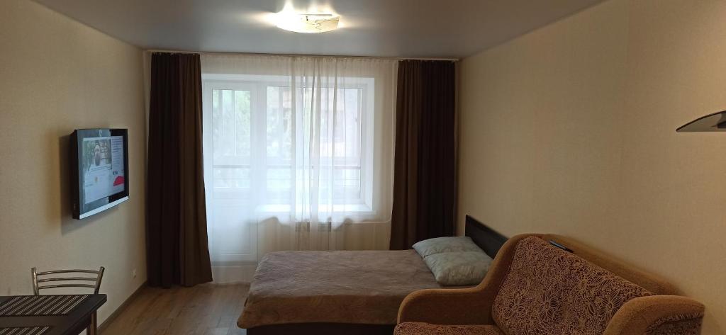 トムスクにあるApartamenty na Matrosovaの小さなベッドルーム(ベッド1台、窓付)