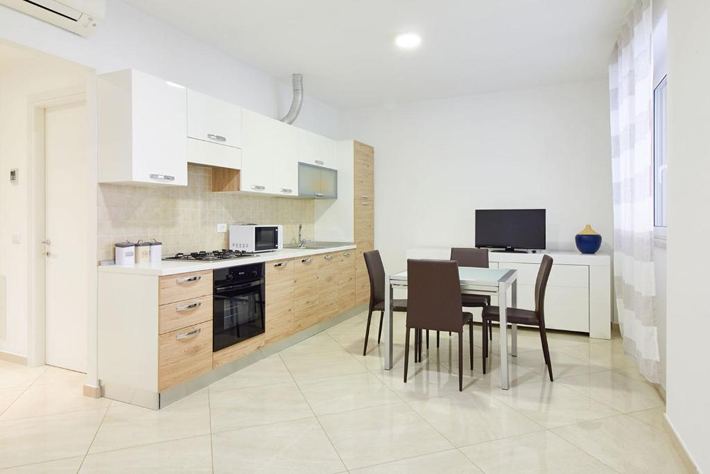 a kitchen with a table and chairs in a room at Spotorno Beach in Spotorno