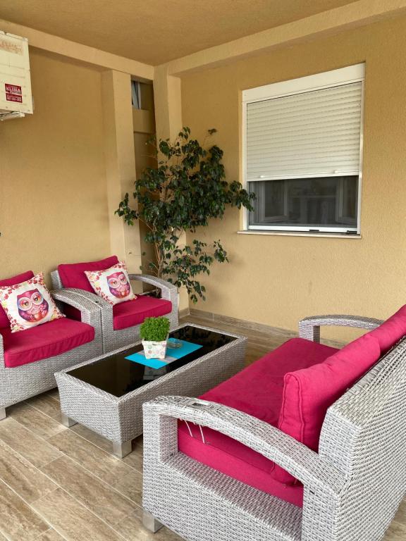 a living room with two couches and a table at Apartments Boss in Budva