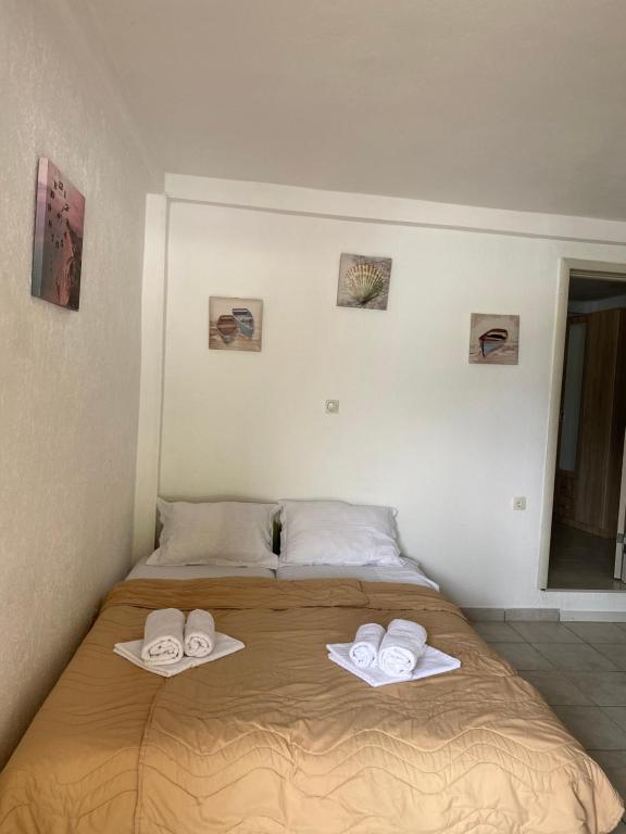 a bed with two towels on top of it at Apartments Boss in Budva