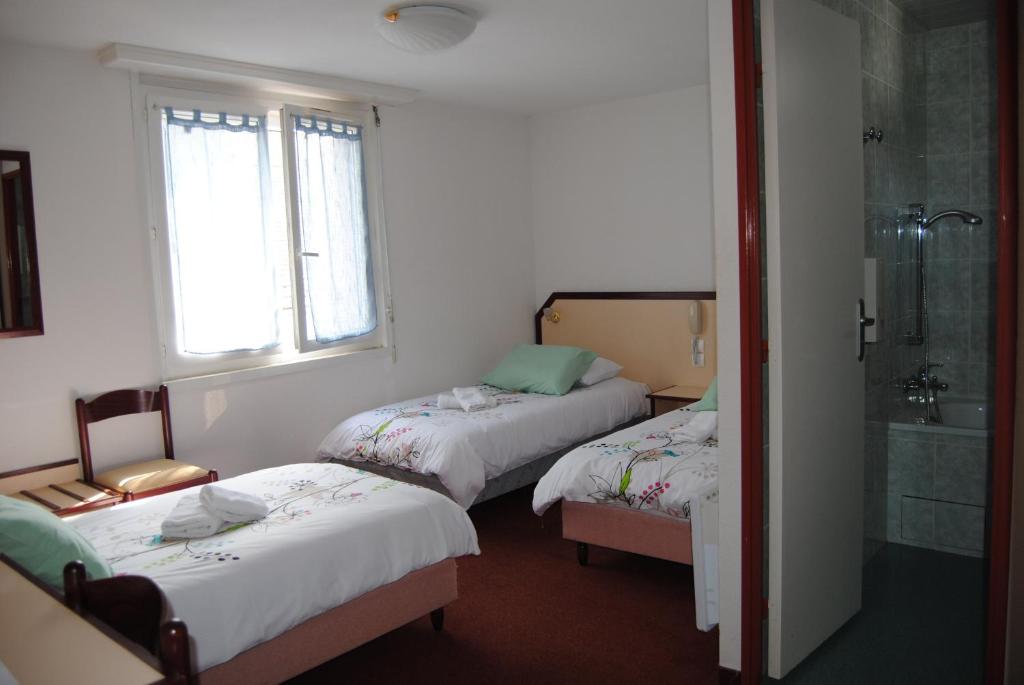Postel nebo postele na pokoji v ubytování Hôtel Myosotis