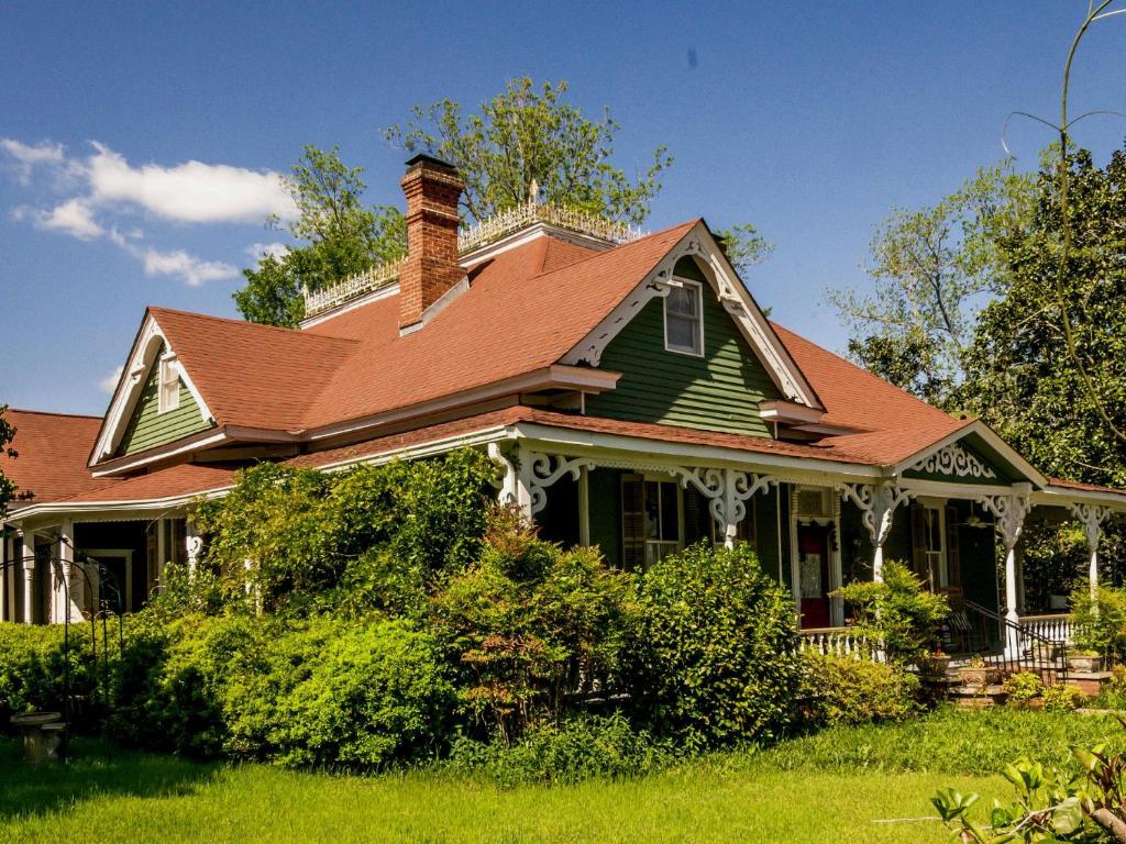 una casa verde con tetto marrone di Holly House of Hamilton a Hamilton