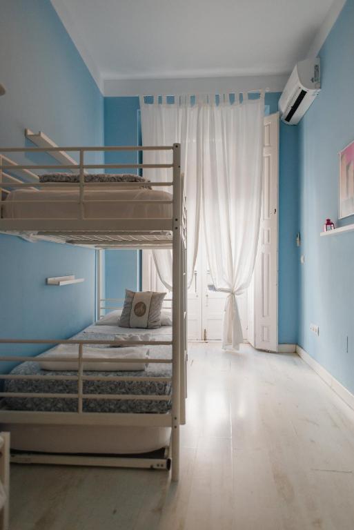 Postel nebo postele na pokoji v ubytování Hostal Vidamia