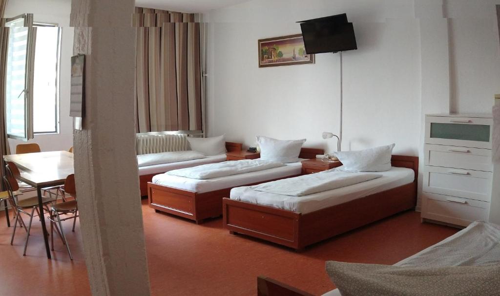 Postel nebo postele na pokoji v ubytování Hostel am Kurtti