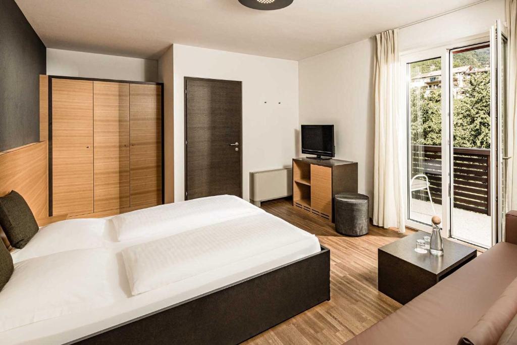 Postel nebo postele na pokoji v ubytování Hotel Traminerhof