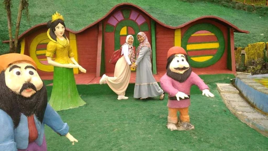 a group of people standing in front of a play house at Pesona Wisata Alam Ciparay Endah in Bogor