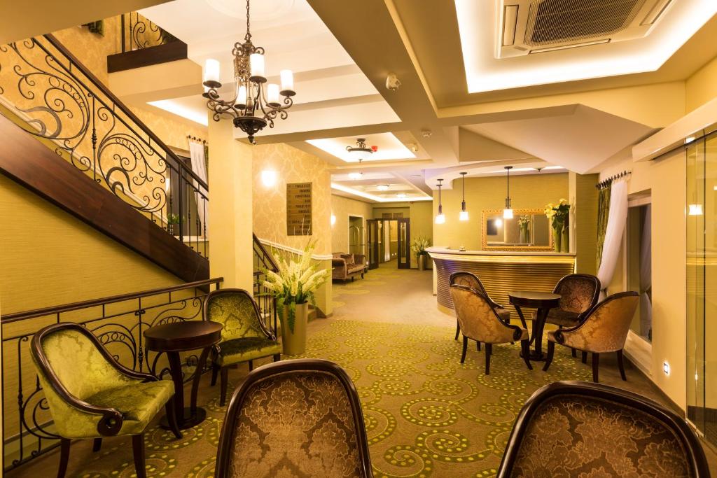 a hotel lobby with chairs and a table at Hotel Dvorana in Karlovy Vary