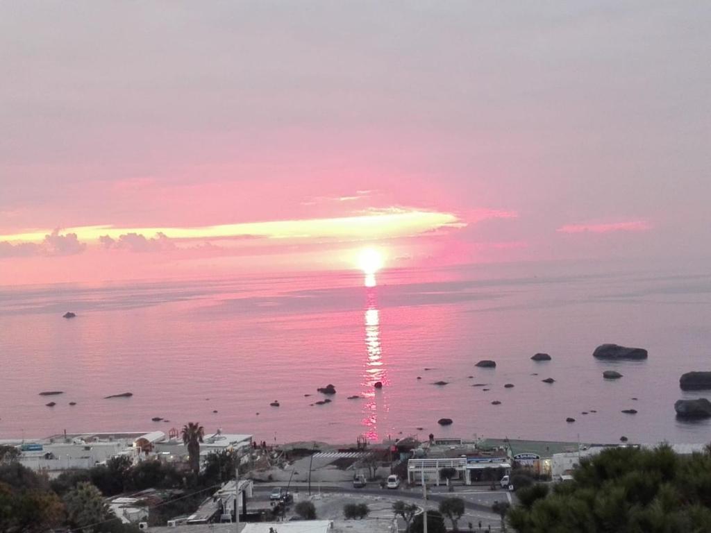 a sunset over a body of water at Casa Le Soleil in Ischia