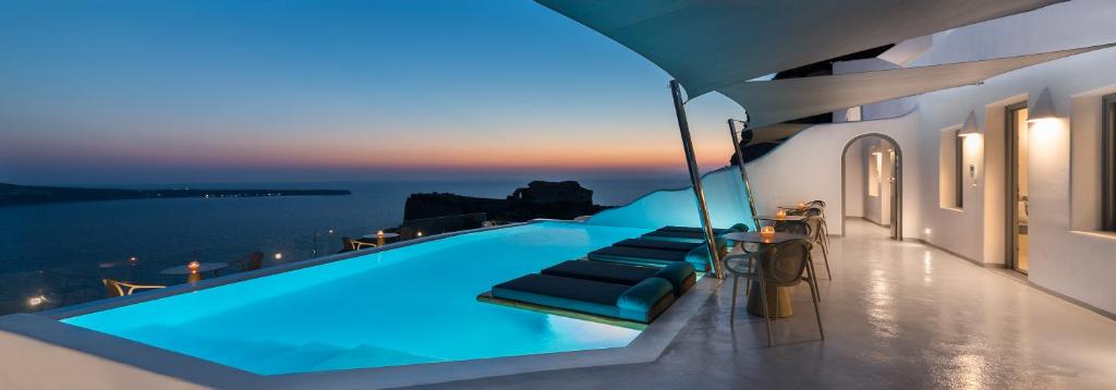 a swimming pool on a house with a view of the ocean at Maregio Suites in Oia