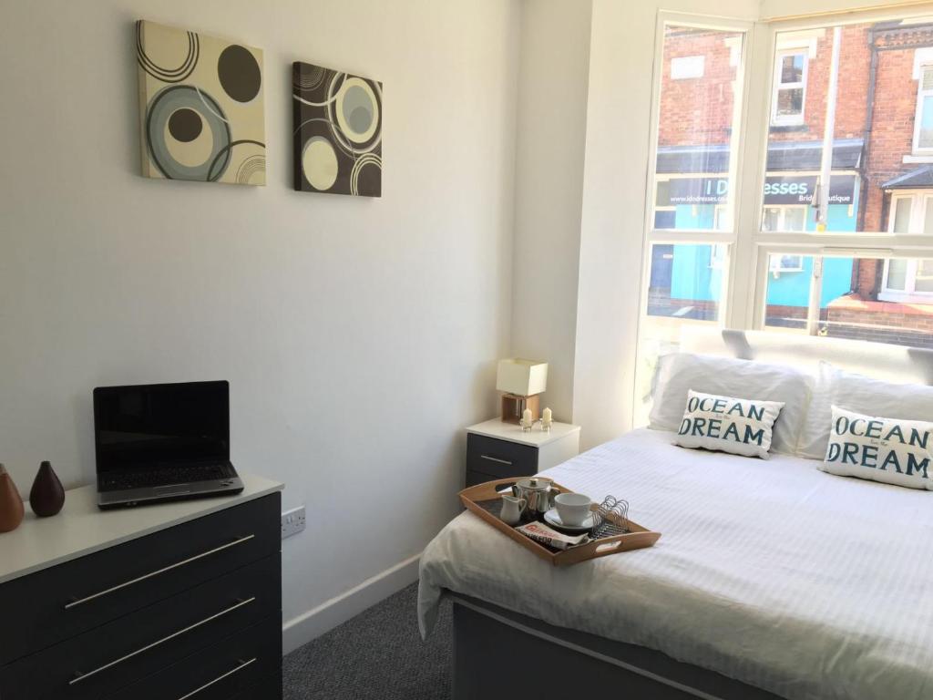 a bedroom with a bed and a tv and a window at Townhouse @ 97 Edleston Road Crewe in Crewe