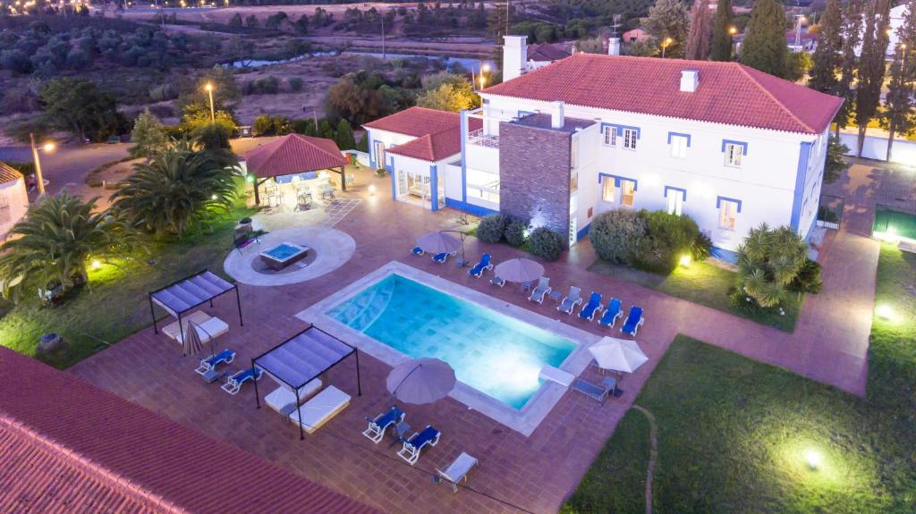 an aerial view of a house with a swimming pool at Hotel Lousal in Lousal