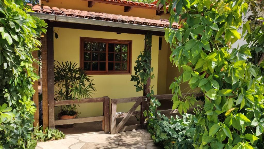 una casa con ventana y valla en Chalés Beira Rio en Pirenópolis