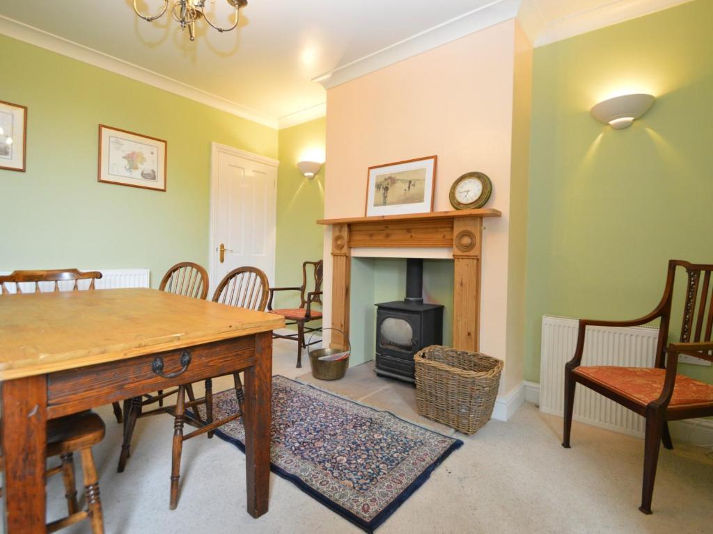 a living room with a table and a fireplace at Lime House in Newark-on-Trent