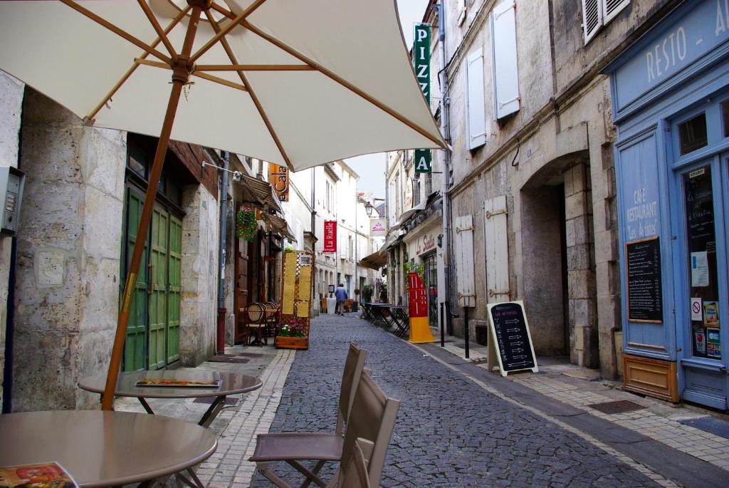 アングレームにあるMaison de la Marbrerieのテーブルと傘が並ぶ空き道