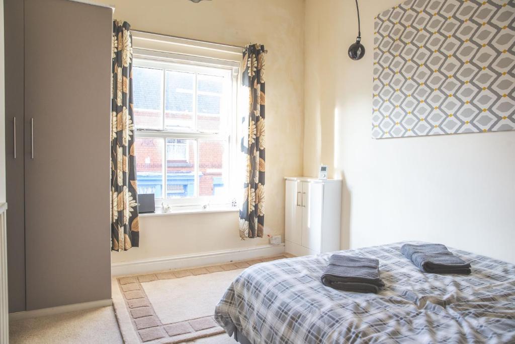 a bedroom with a bed and a window at Ibstock Self Catered Apartment in Ibstock