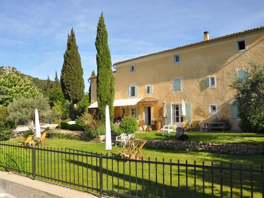 a large house with a fence in front of it at Le Mas de la Lause in Le Barroux