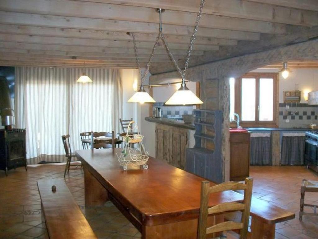 uma cozinha e sala de jantar com uma mesa de madeira em Ker Peric em Saint-Pierre-dels-Forcats