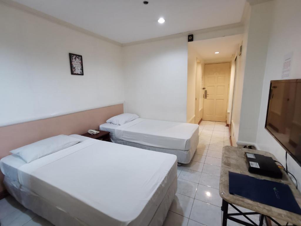 Postel nebo postele na pokoji v ubytování Metro Park Hotel - Cebu City