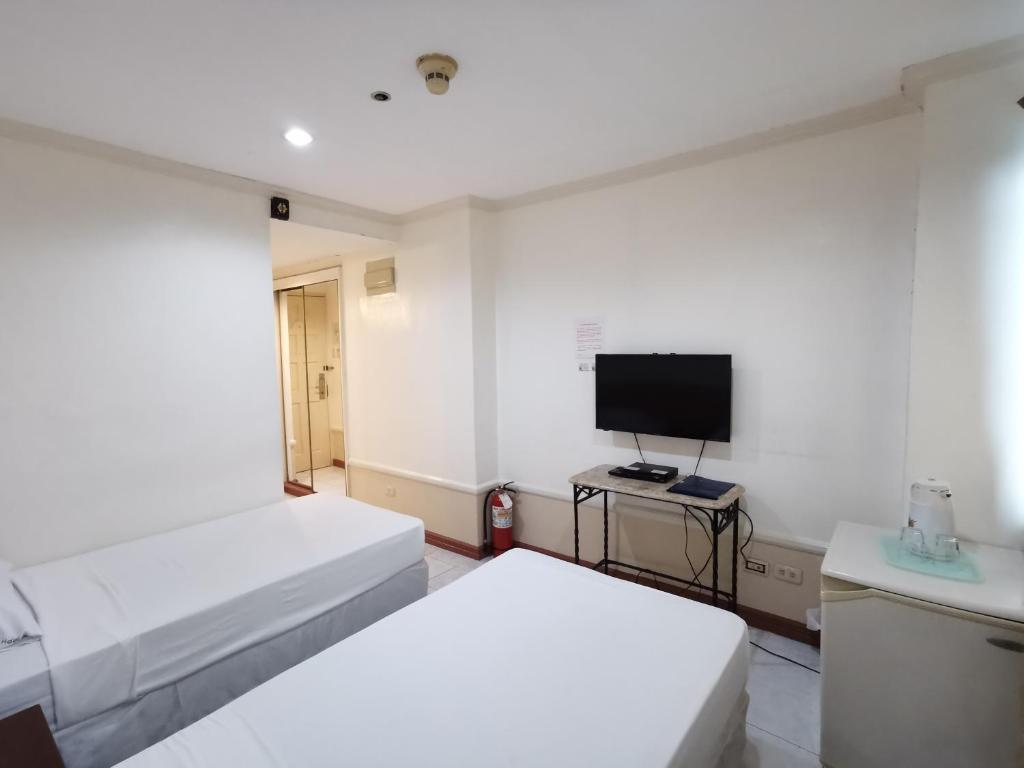 Postel nebo postele na pokoji v ubytování Metro Park Hotel - Cebu City