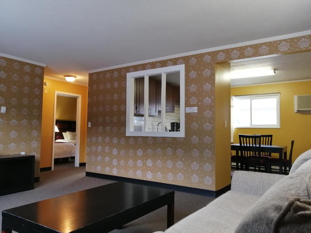 a living room with a couch and a table at Alpine Inn & Suites in Revelstoke